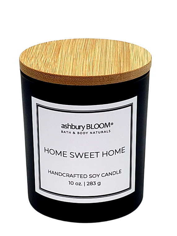 Home Sweet Home Soy Wax Candle - a beautifully crafted soy wax candle by ashbury BLOOM in a glass jar, emitting a warm and inviting glow. The candle is made from natural soy wax, offering a clean and long-lasting burn. It features a delicate fragrance of refreshing scent of afternoon sunshine on clay, followed by the exotic notes of saffron and peppery spice, perfect for creating a cozy atmosphere in any room