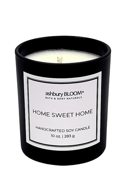 Home Sweet Home - a beautifully crafted soy wax candle by ashbury BLOOM in a glass jar, emitting a warm and inviting glow. The candle is made from natural soy wax, offering a clean and long-lasting burn. It features a delicate fragrance of refreshing scent of afternoon sunshine on clay, followed by the exotic notes of saffron and peppery spice, perfect for creating a cozy atmosphere in any room