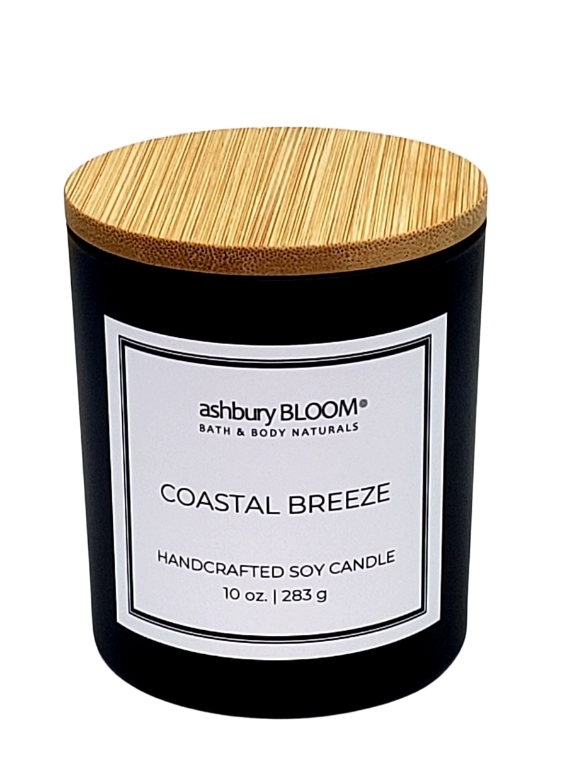 Coastal Breeze Soy Wax Candle - A beautifully crafted soy wax candle by ashbury BLOOM in a glass jar, emitting a warm and inviting glow. The candle is made from natural soy wax, offering a clean and long-lasting burn. It features a delicate fragrance of the coast, this candle brings together sea salt oasis, notes of pear blossom and waterlily for a calming and grounding effect, perfect for creating a cozy atmosphere in any room.