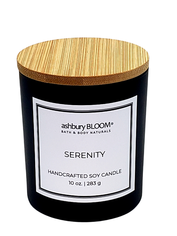 Serenity Soy Wax Candle Canada - A beautifully crafted soy wax candle by ashbury BLOOM in a glass jar, emitting a warm and inviting glow. The candle is made from natural soy wax, offering a clean and long-lasting burn. It features a delicate fragrance of top notes of orange and bergamot, a warm heart of cinnamon and clove, and lingering aromas of patchouli, perfect for creating a cozy atmosphere in any room.