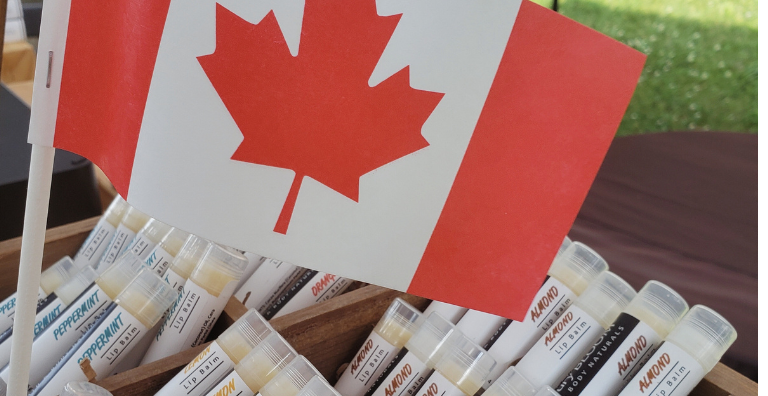 Assortment of Ashbury Bloom lip balms featuring a Canadian flag design on the packaging, highlighting their Canadian heritage and product origin.