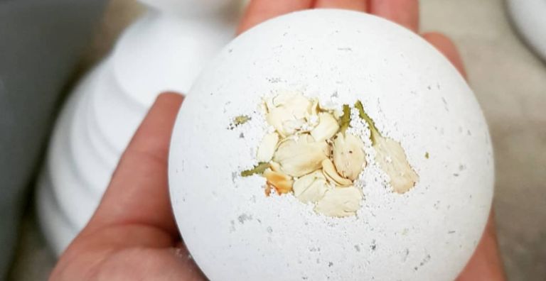 Ashbury Bloom Refreshing escape Bath bomb being held in the hand.